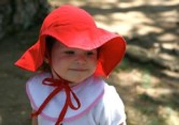 Young child in a red sun hat