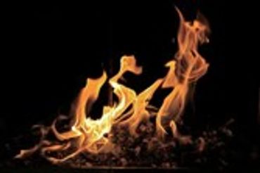 Bright orange flames dancing against a dark background