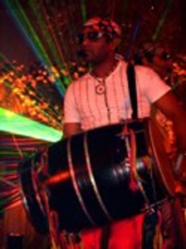 Person playing a drum on a stage