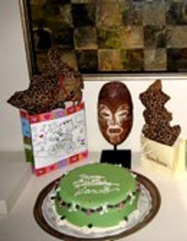 Decorated cake and chocolate desserts on a table.