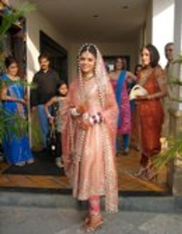 Bride in a pink dress and guests at a wedding