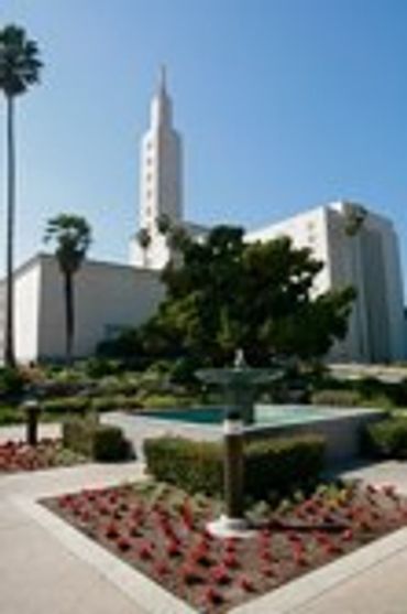 Temple building with a fountain and manicured garden.
