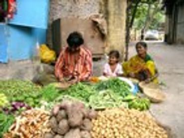 People preparing food on the ground