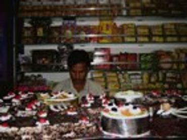 Shop interior with cakes and baked goods.
