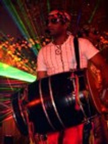 Person playing a drum at an event.