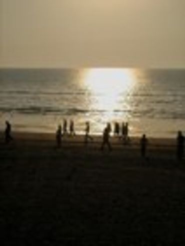 People on a beach at sunset