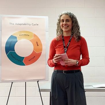 Woman presenting the Adaptability Cycle chart in a workshop.