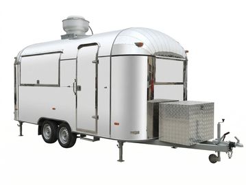 Silver metallic travel trailer with dual axles and front storage box.