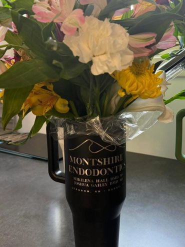 Flowers in a Montshire Endodontics cup.