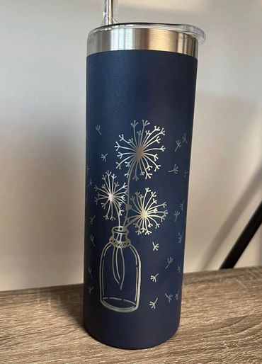 A navy blue tumbler with dandelion design.
