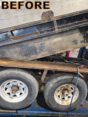 Rusty and dirty trailer wheels with worn tires before cleaning.