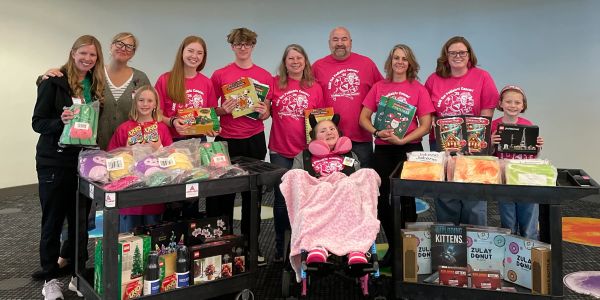 Group of people with donation items and gifts.