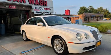 a car parked outside a car wash shop 