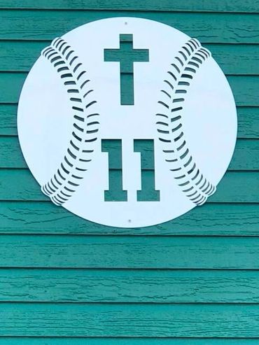 Metal sign at AHS baseball field includes number 11 and a cross.