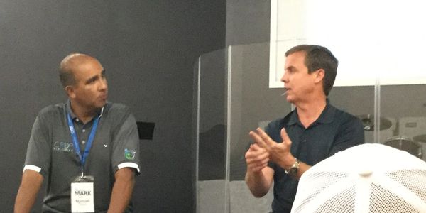 Kurt Varricchio speaking with students and parents at a church function
