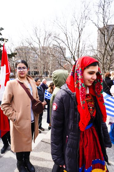 Women in traditional and modern clothing at a public gathering.