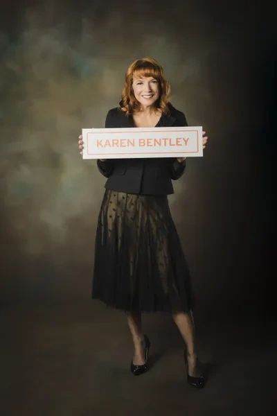 Karen Bentley holding up a sign.