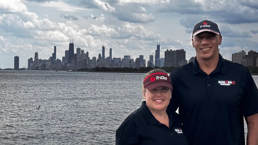 Stack of books next to pencils in a holder and a camera.