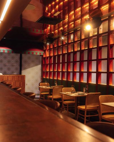 Cozy restaurant interior with wooden furniture and warm lighting.