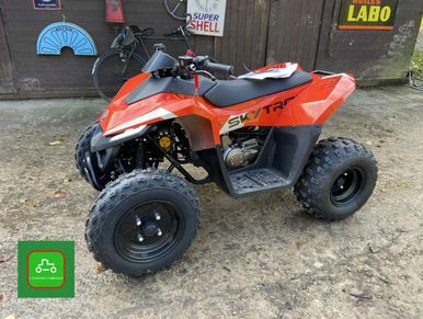 Red SkyTar all-terrain quad bike with large tires parked outdoors.