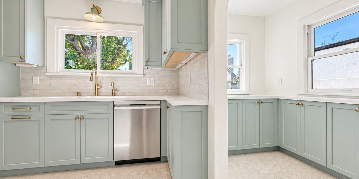 Altadena kitchen remodel: Grenier Construction with sage cabinets, brass faucet and tile backsplash.