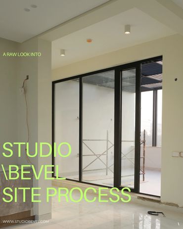 Interior view of a modern space under construction with large glass doors.