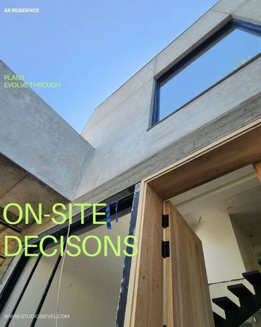 Modern concrete and wood residence under construction with clear blue sky.