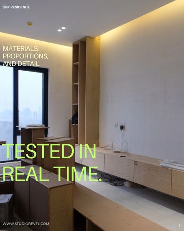 Modern minimalistic wooden furniture in a softly lit room under construction.