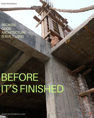 Concrete and brick structure under construction with wooden scaffolding.