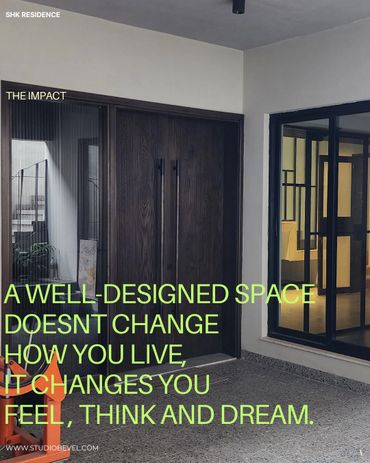 Modern entrance with dark wood doors and glass panels in a stylish residence.