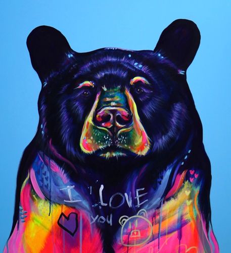 Stack of books next to pencils in a holder and a camera.