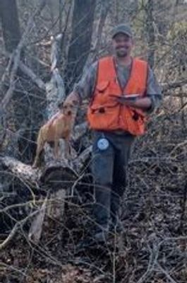 A person taking a picture with the dog