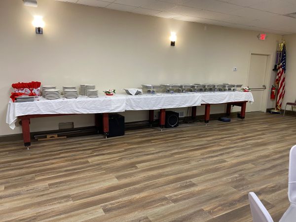 Buffet table set up in a room with wooden floor.
