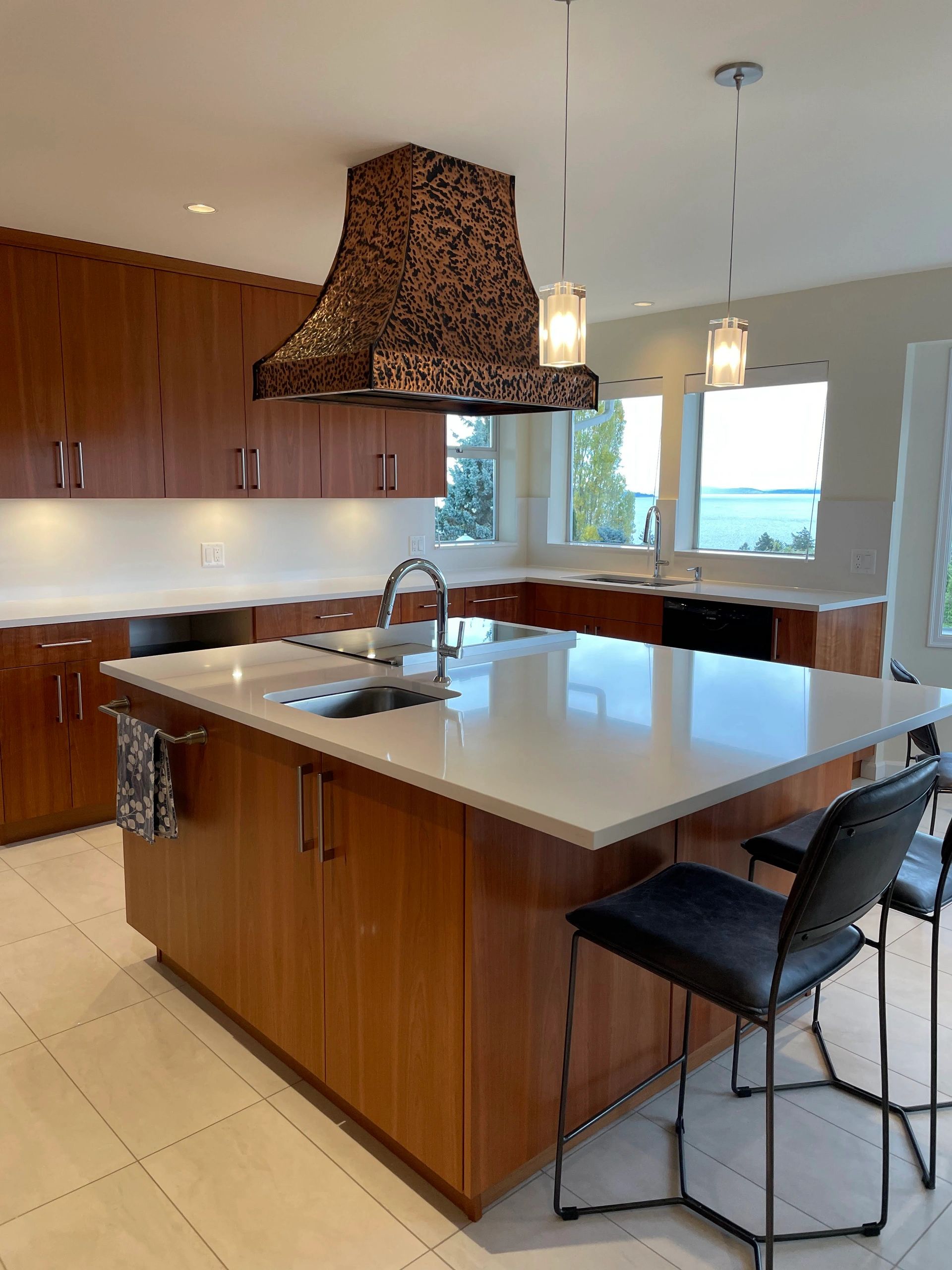 Beautiful kitchen renovation with a view of the water, reused hoodfan