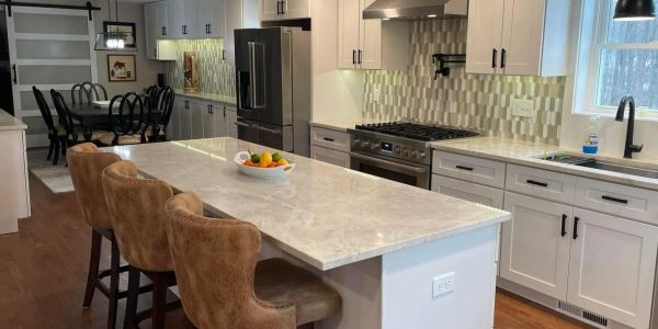 Modern kitchen with large island and bar stools.