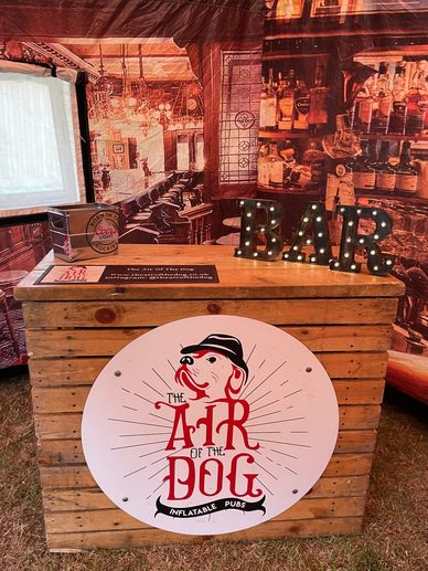 Wooden bar complete with bar sign, ice bucket and beer mat