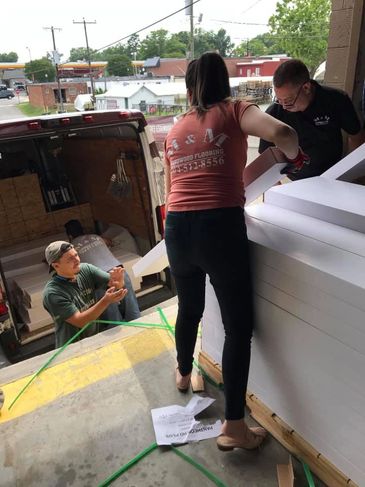 Family members loading a flooring project.