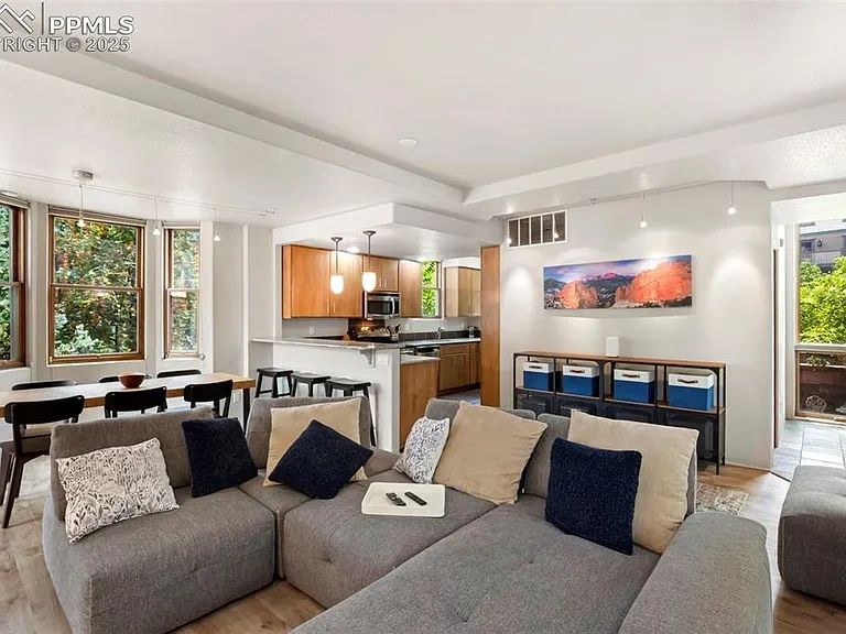Modern open-concept living room with kitchen and dining area.