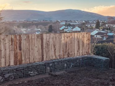 Gabion wall faced with timber fencing