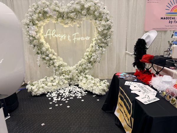 Heart-shaped floral arrangement with 'Always &amp; Forever' neon sign.