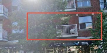 A balcony with a chair and air conditioner on a sunny day.
