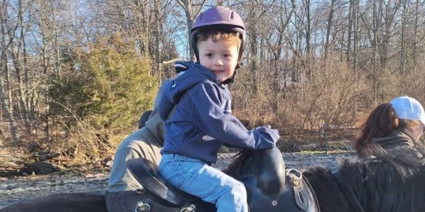 Child on a pony looking at the camera