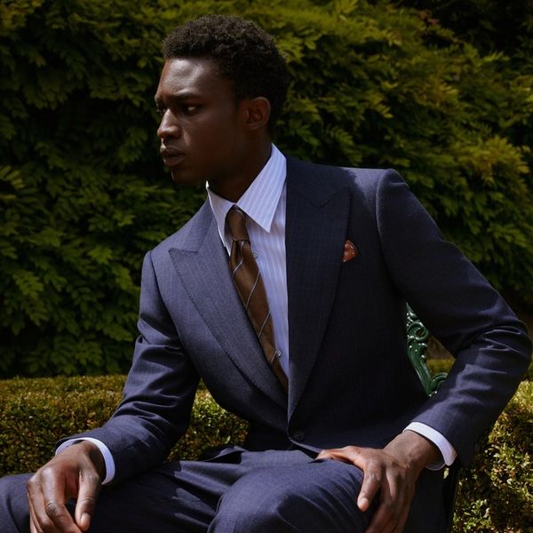 A sharp-dressed young man in a navy suit