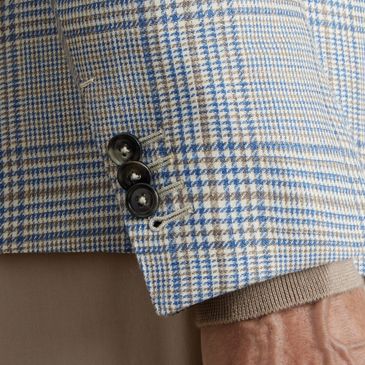 Close-up of sleeve button detail on plaid sport coat