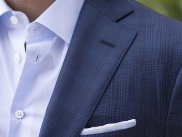 Close-up of dress shirt and suit jacket with pocket square