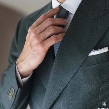 Man adjusting tie