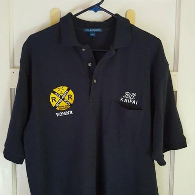 Black polo shirt with embroidered railroad and name designs.
