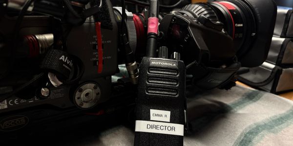 Director's walkie-talkie and professional camera.