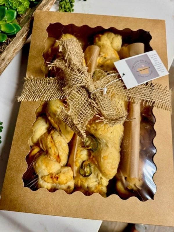 Box of assorted savory breadsticks tied with rustic burlap ribbon.