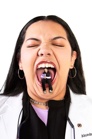 Person with a tiny sitting figure inside their open mouth.